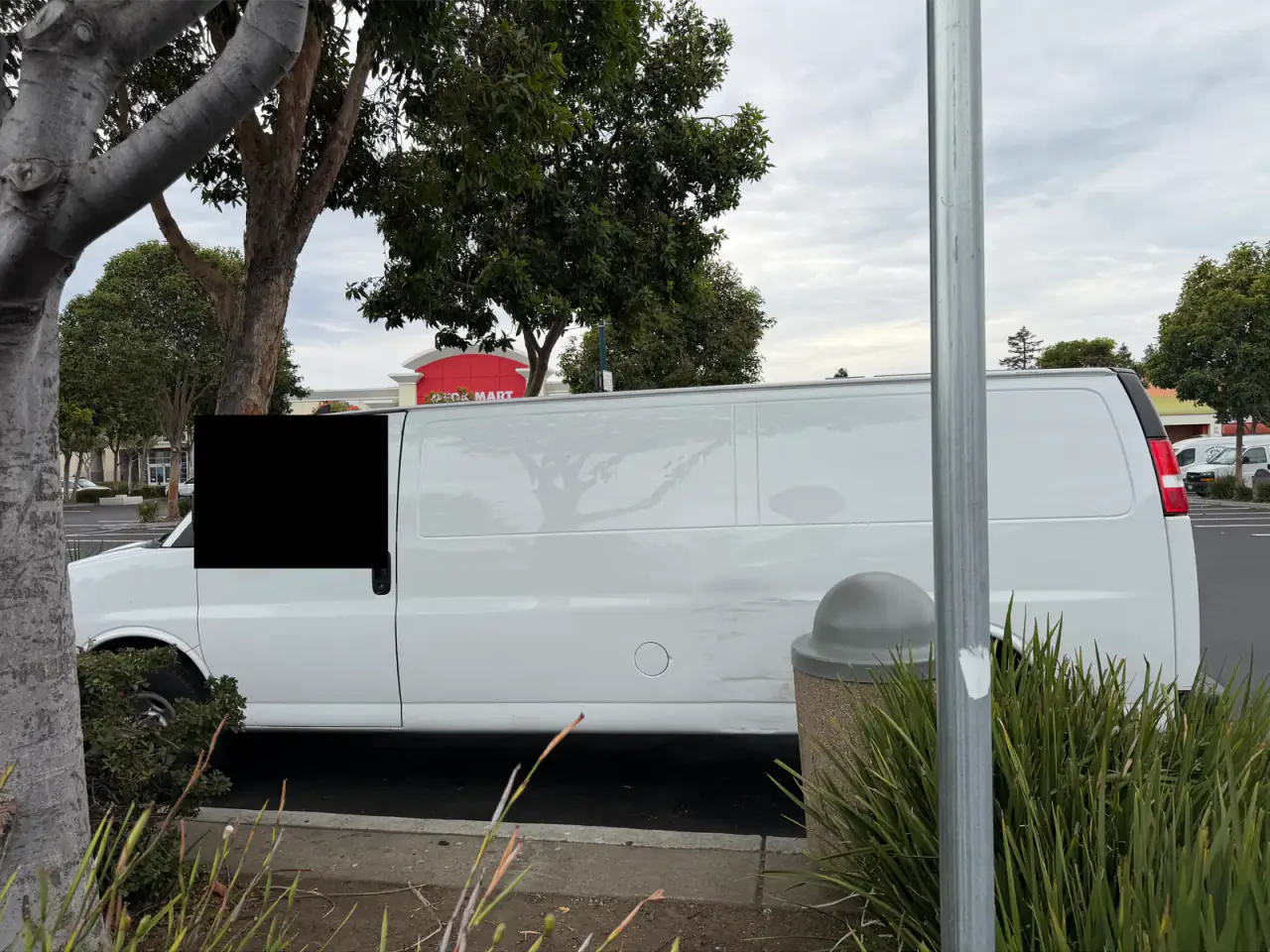 White Chevrolet Express cargo van, driver side