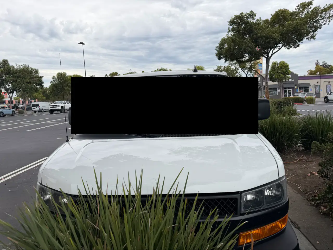White Chevrolet Express cargo van, hood