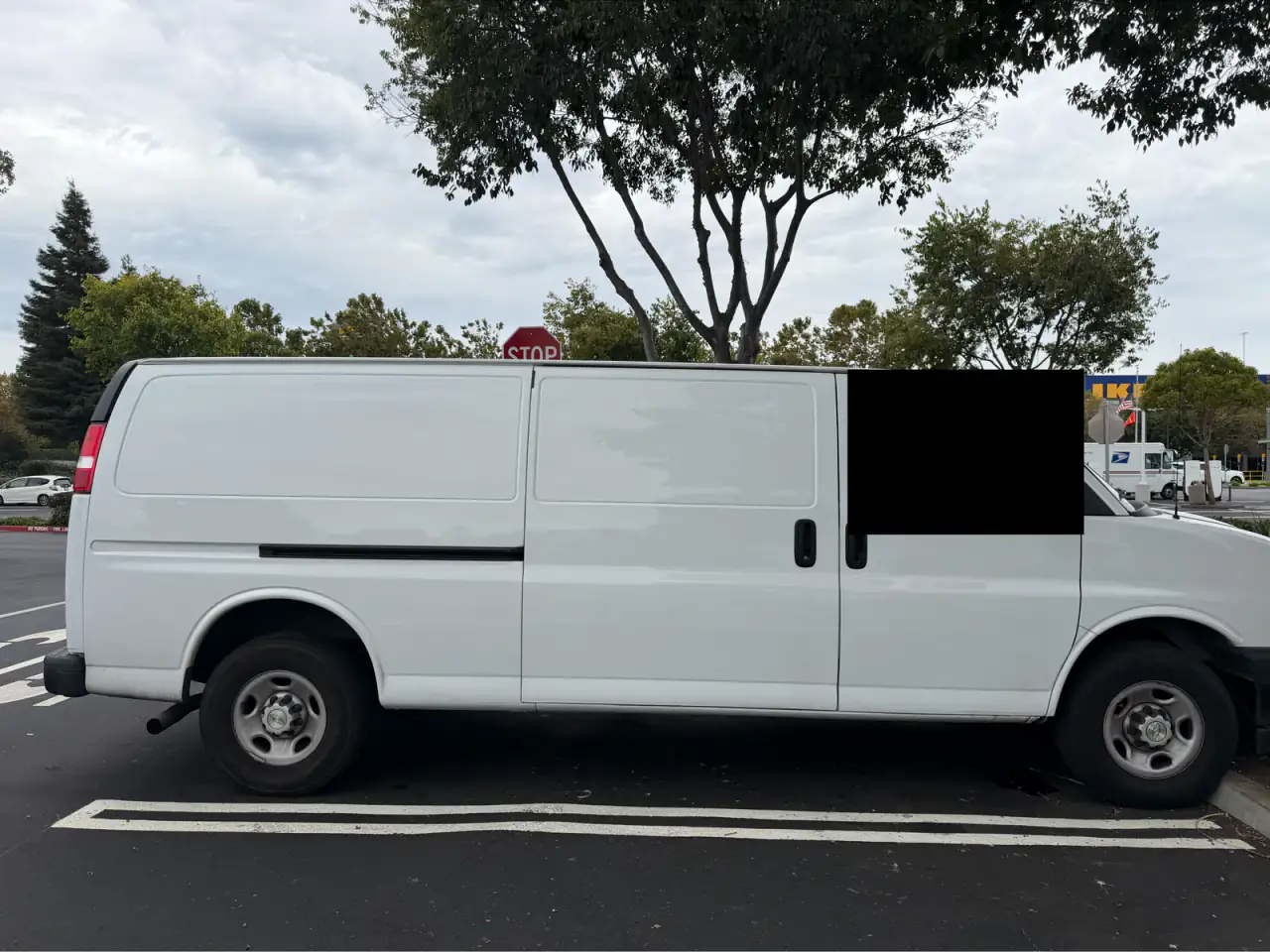 White Chevrolet Express cargo van, sliding-door side